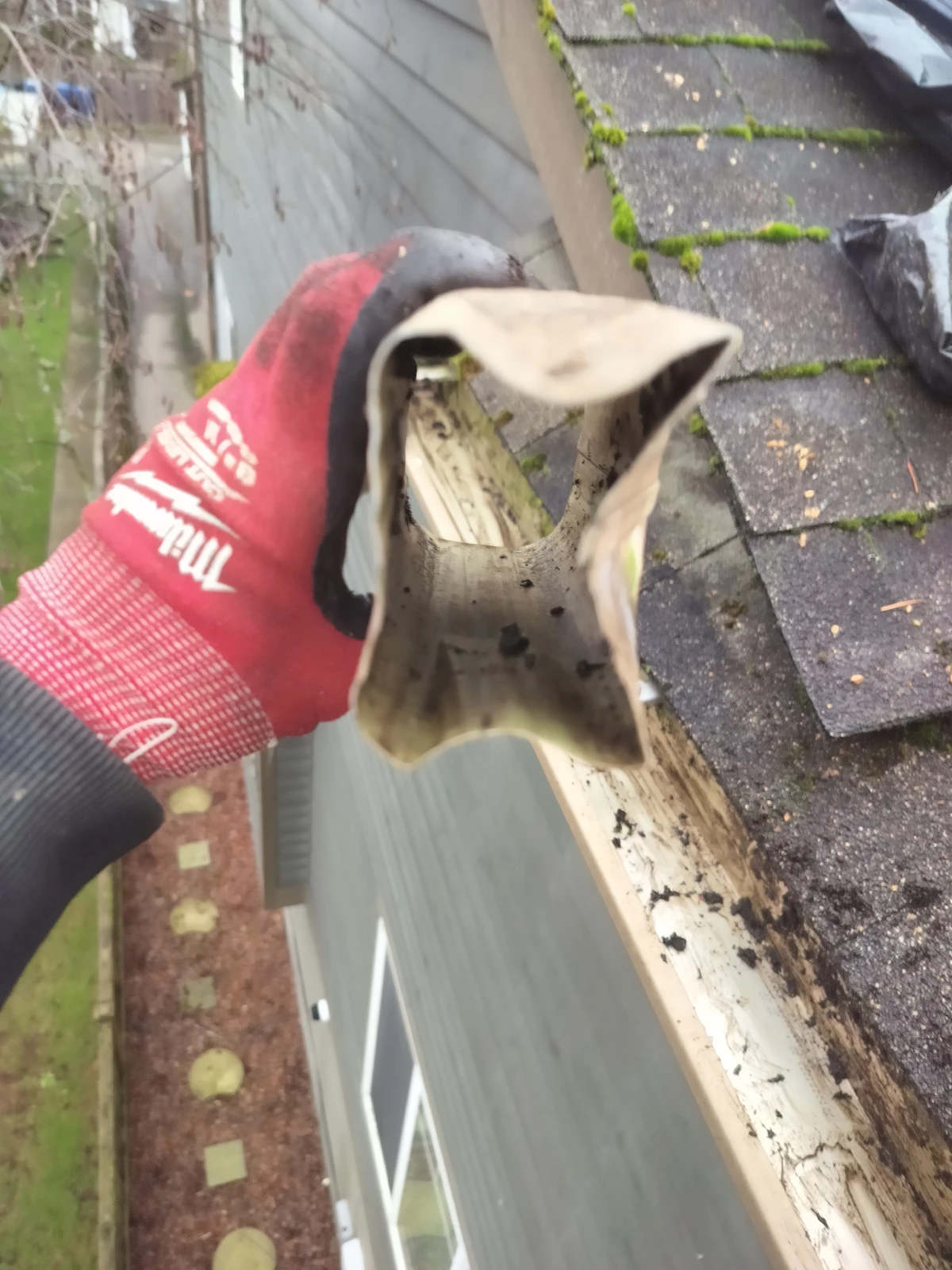 A downspout that has been squeezed too tight in order to fit