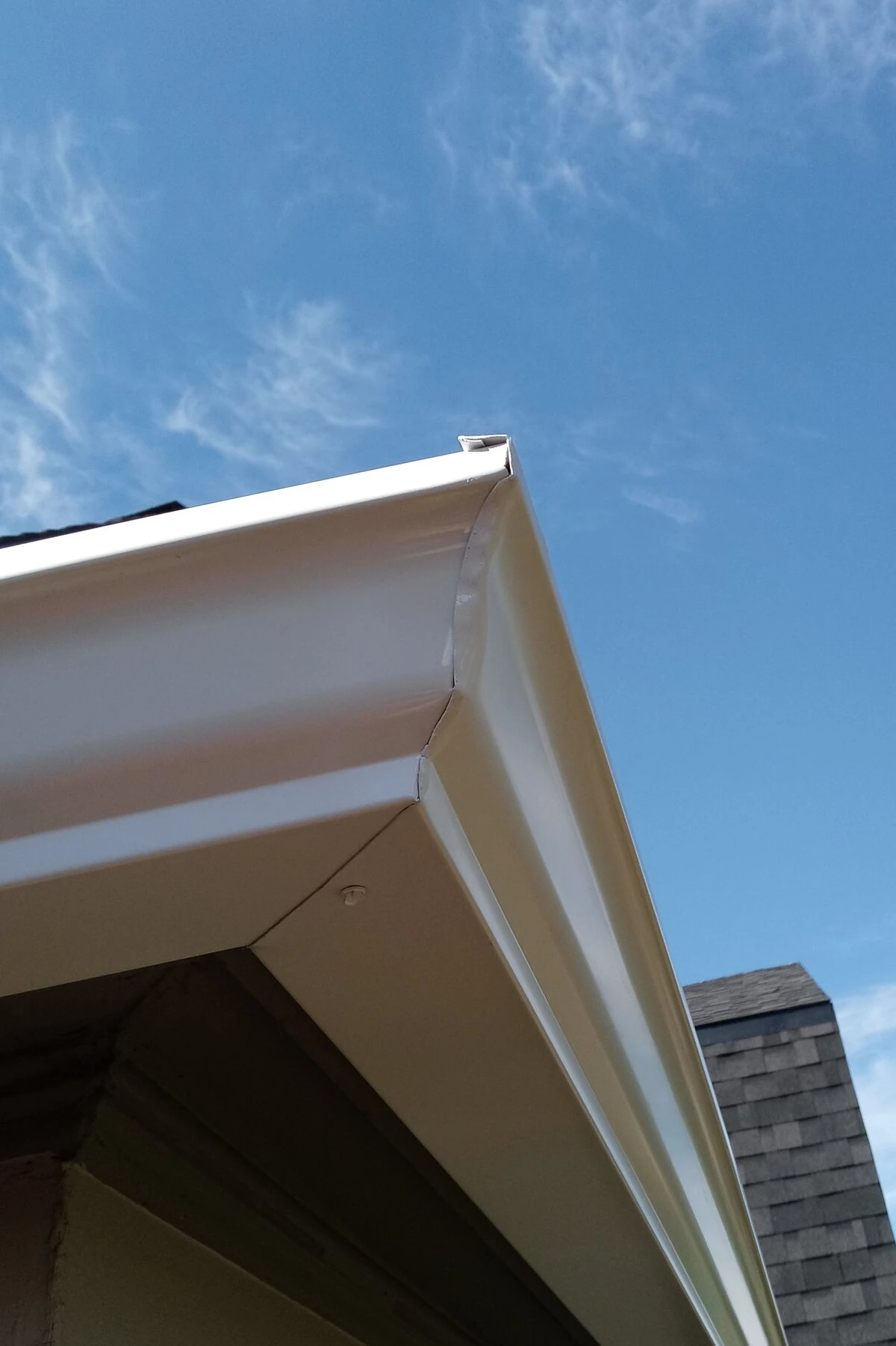 A professionally hand cut miter outside corner, white 5k gutter.