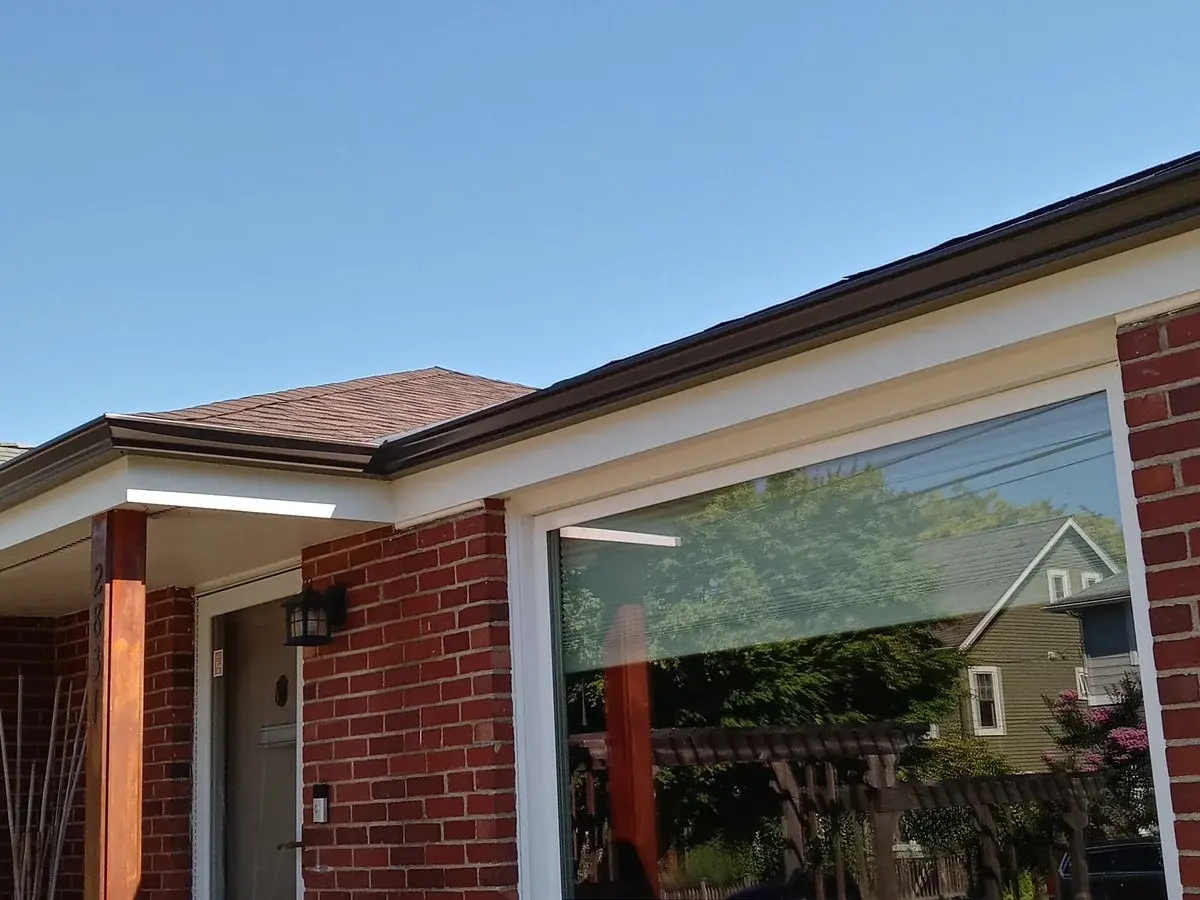 New black gutters on a brick house